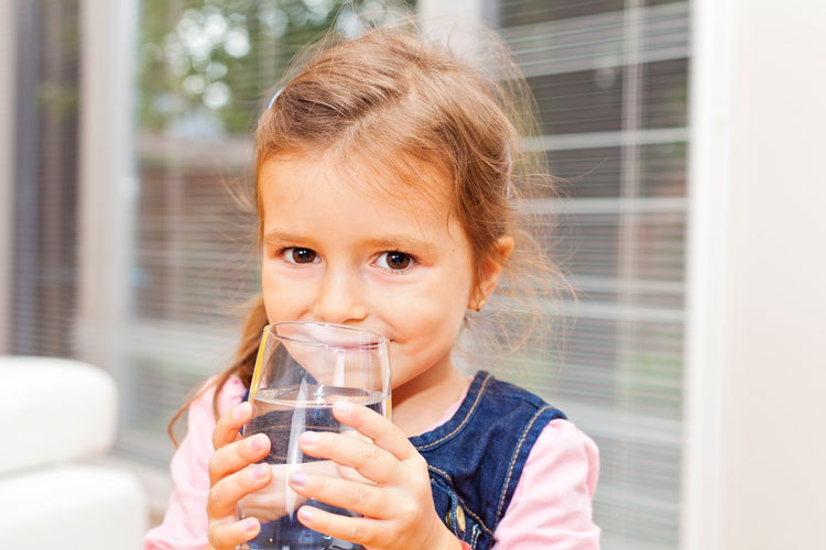 Little girl drinking clean water.